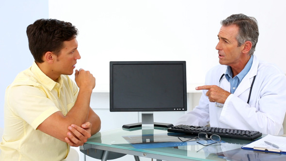 Patient Explaining Elbow Pain To His Doctor Patient Explaining Elbow Pain To His Doctor