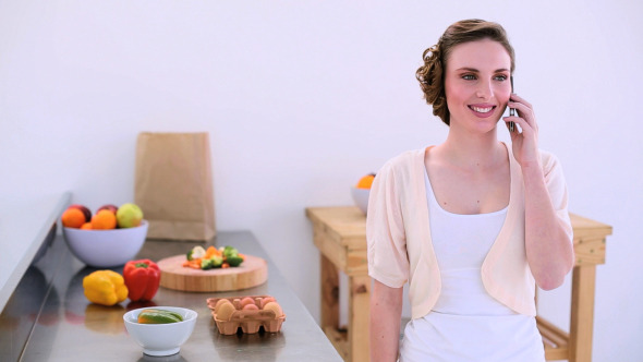 Pretty Model Standing In Kitchen Chatting Pretty Model Standing In Kitchen Chatting