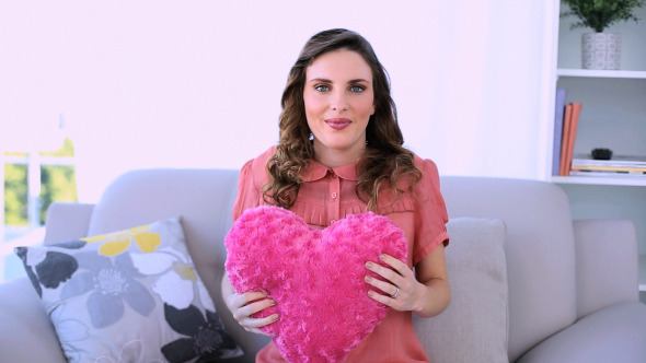 Pretty Pregnant Model Sitting Hugging A Pillow Pretty Pregnant Model Sitting Hugging A Pillow