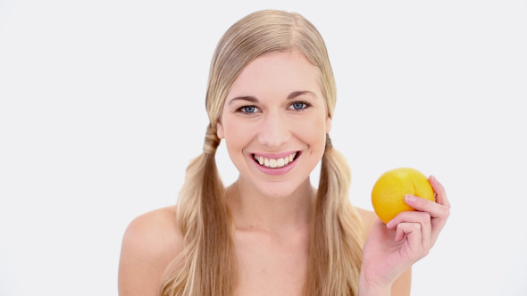 Happy Nude Blonde Holding Orange Happy Nude Blonde Holding Orange