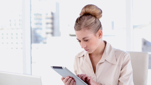 Happy Blonde Businesswoman Using Tablet Happy Blonde Businesswoman Using Tablet