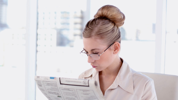 Content Blonde Businesswoman Reading Newspaper Content Blonde Businesswoman Reading Newspaper