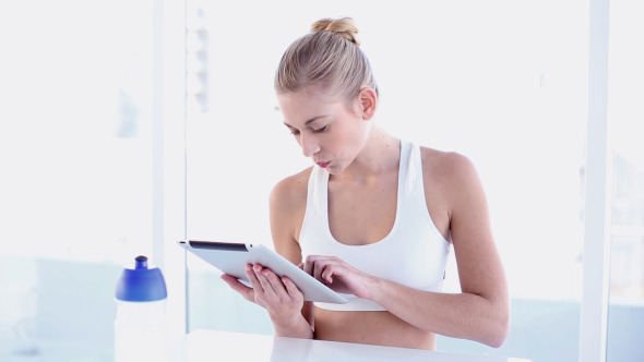 Sporty Smiling Blonde Using Tablet Sporty Smiling Blonde Using Tablet