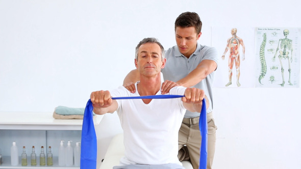 Physiotherapist Checking Mature Patient Stretching Physiotherapist Checking Mature Patient Stretching