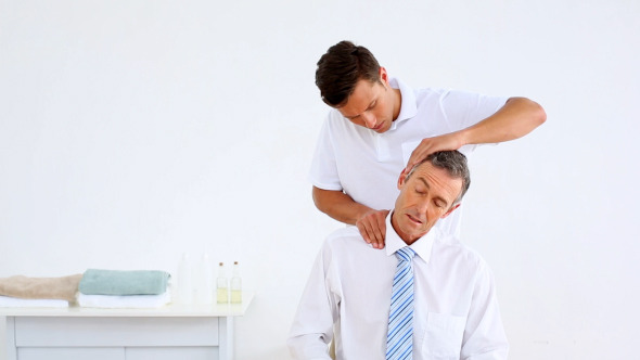 Physiotherapist Giving Businessman A Massage 1 Physiotherapist Giving Businessman A Massage 1