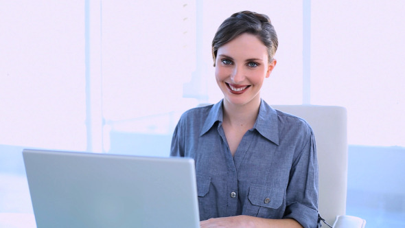 Happy Businesswoman Working On A Laptop 1 Happy Businesswoman Working On A Laptop 1