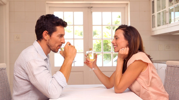 Happy Man Giving His Partner A Present At Table Happy Man Giving His Partner A Present At Table