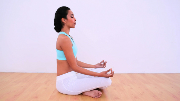 Peaceful Woman Meditating In Lotus Position Peaceful Woman Meditating In Lotus Position