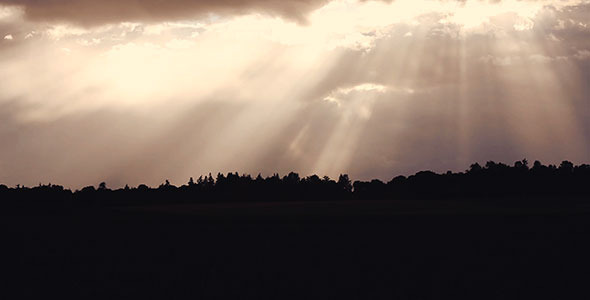 Sun Rays Peek Through Clouds on Country Corn Field by brianckaufman