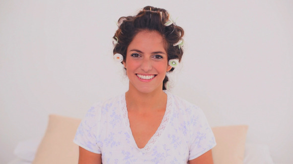 Happy Woman In Hair Curlers Applying Gloss Happy Woman In Hair Curlers Applying Gloss