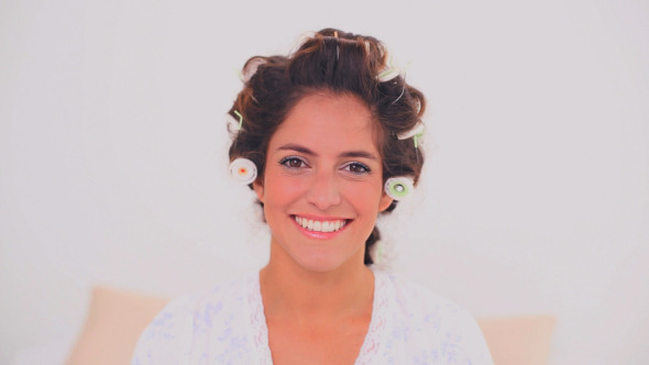 Content Woman In Hair Curlers Applying Powder Content Woman In Hair Curlers Applying Powder