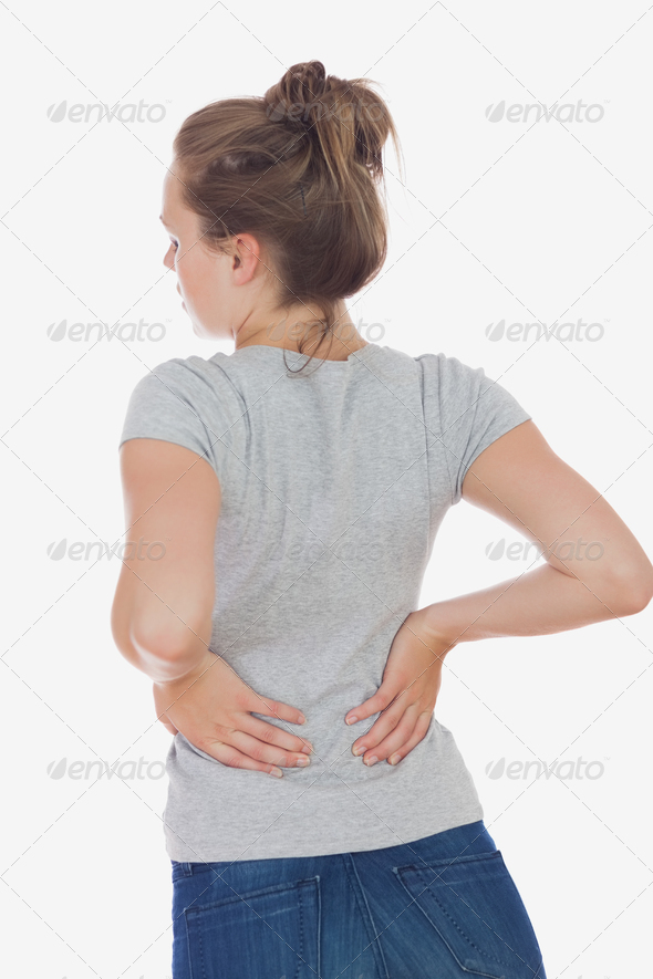 Rear view of young woman suffering from back pain against white background (Misc) Photo Download