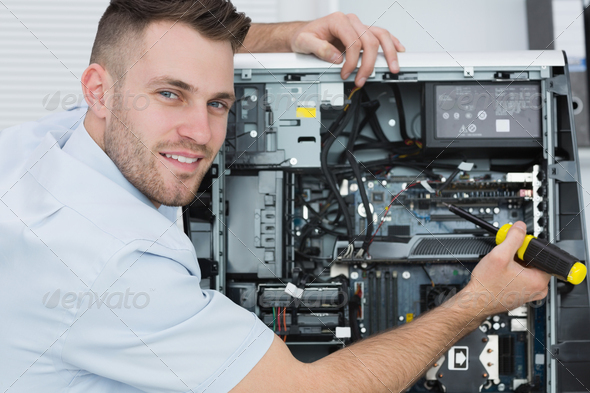 Portrait of young computer engineer working on cpu at workplace (Misc) Photo Download