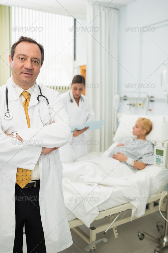 Doctor folding his arms in maternity ward (Misc) Photo Download