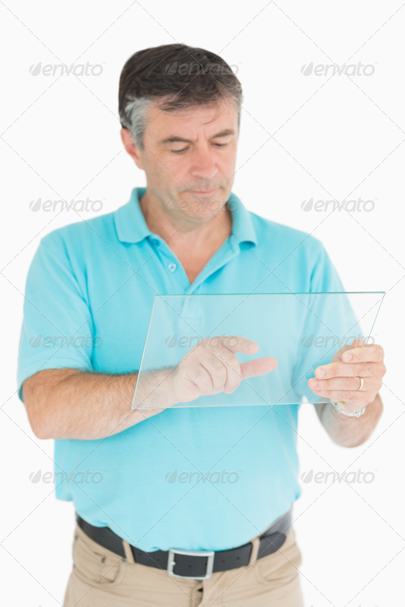 Man pointing on glass slide as digital tablet while looking thoughtful (Misc) Photo Download