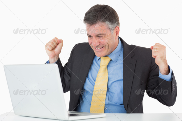 Very happy man sitting at his desk with his laptop on white background (Misc) Photo Download