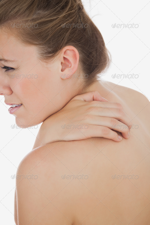 Young woman massaging her back over white background (Misc) Photo Download