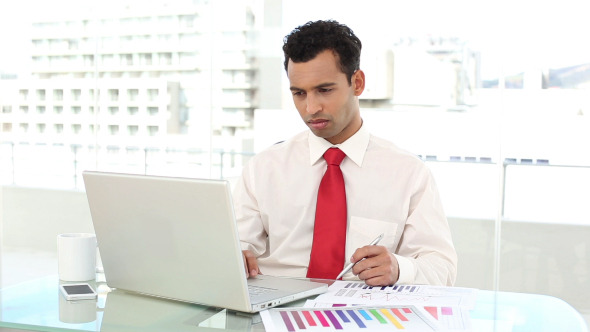 Stern Handsome Businessman Checking Statistics Stern Handsome Businessman Checking Statistics