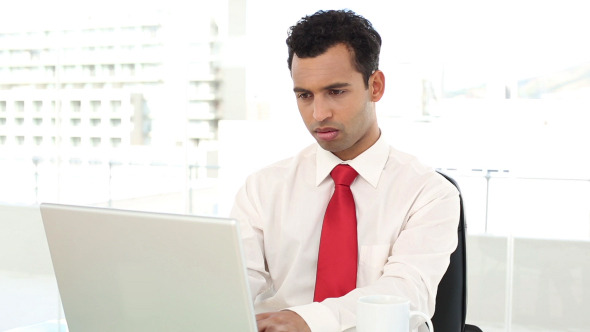 Smiling Handsome Businessman Typing On Laptop Smiling Handsome Businessman Typing On Laptop