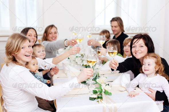 Family And Friends Toasting Wineglasses At Restaurant Table