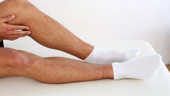 Doctor Checking Sportsmans Injured Ankle Doctor Checking Sportsmans Injured Ankle