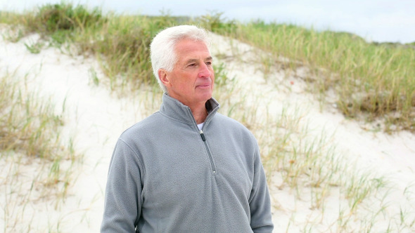 Retired Man Standing On The Beach Retired Man Standing On The Beach