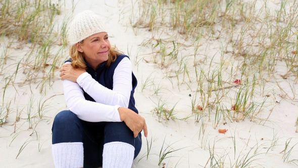 Retired Woman Relaxing On The Beach Retired Woman Relaxing On The Beach