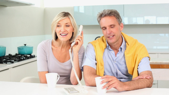 Couple Talking On The Telephone Together Couple Talking On The Telephone Together
