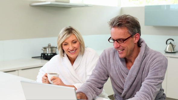 Couple Shopping Online At Breakfast Time Couple Shopping Online At Breakfast Time