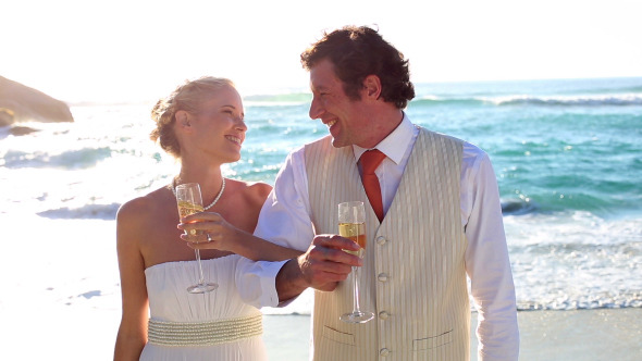 Newlyweds Drinking Champagne On The Beach Newlyweds Drinking Champagne On The Beach
