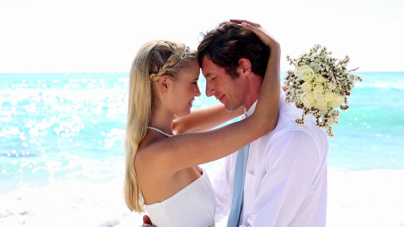 Newlyweds Embracing On The Beach Newlyweds Embracing On The Beach