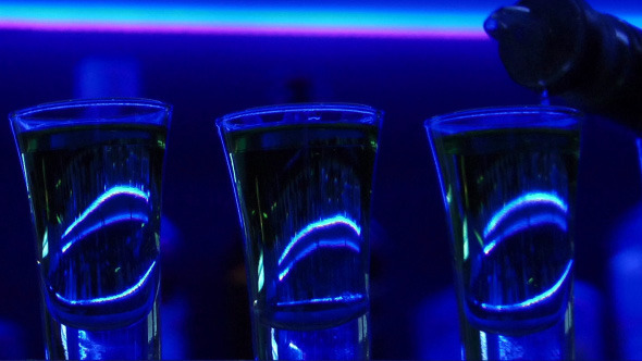 Pouring Three Shots of Clear Alcoholic Drink Pouring Three Shots of Clear Alcoholic Drink